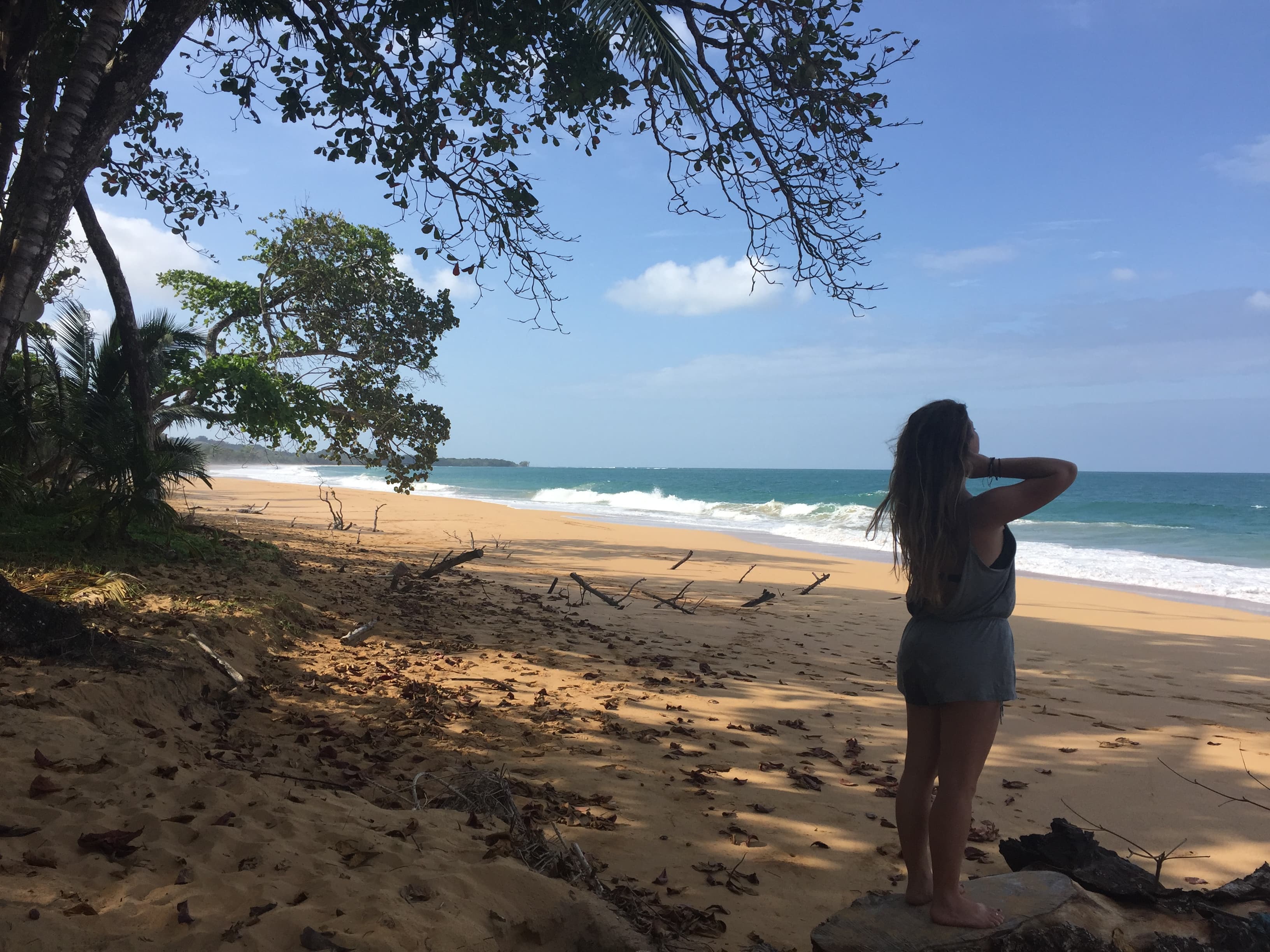 a girl standing on the beach