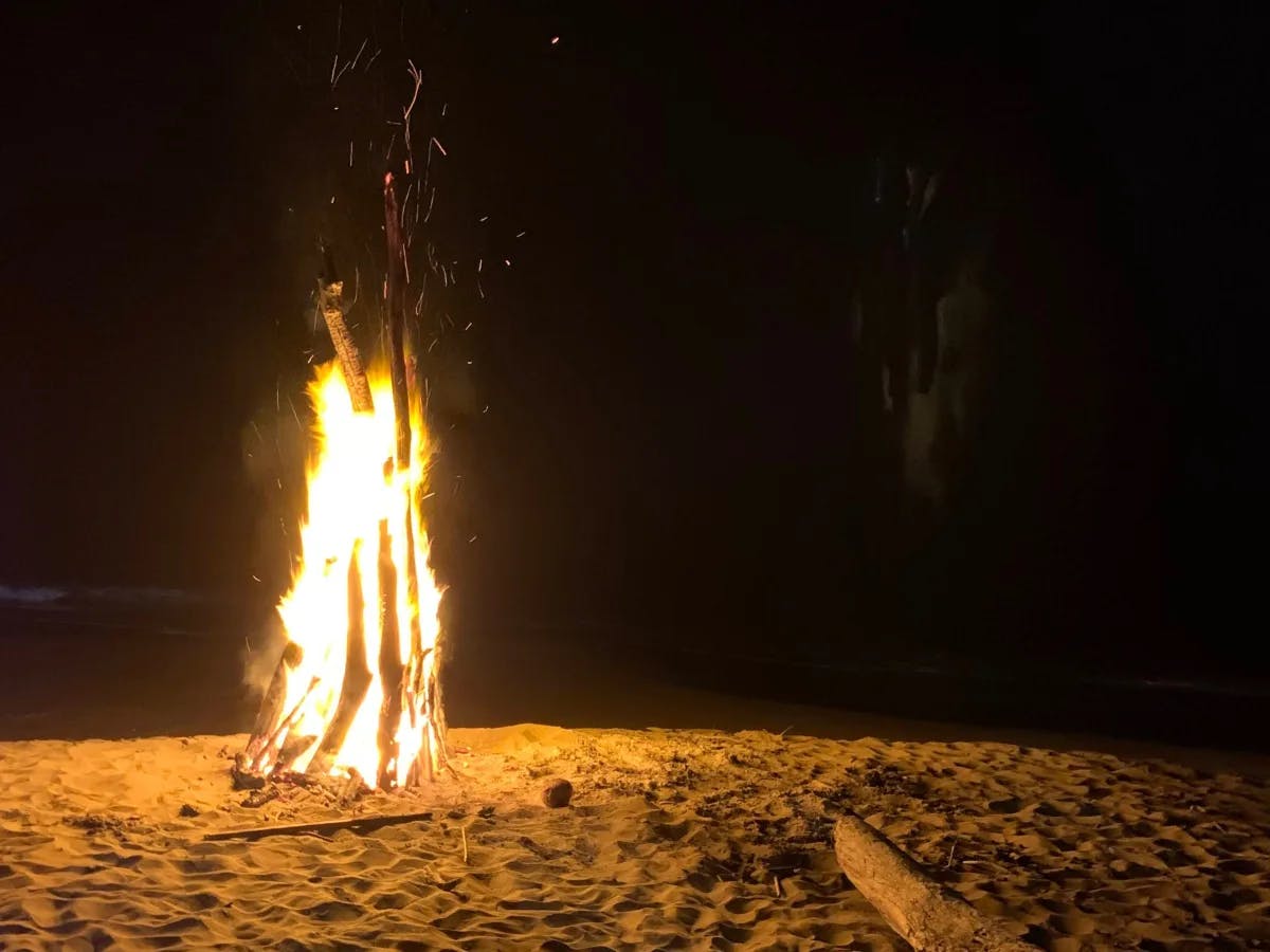 A bonfire on the sand on a dark night 