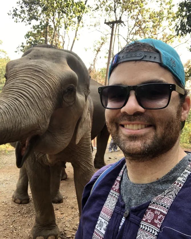 Greg smiling in a selfie with elephant