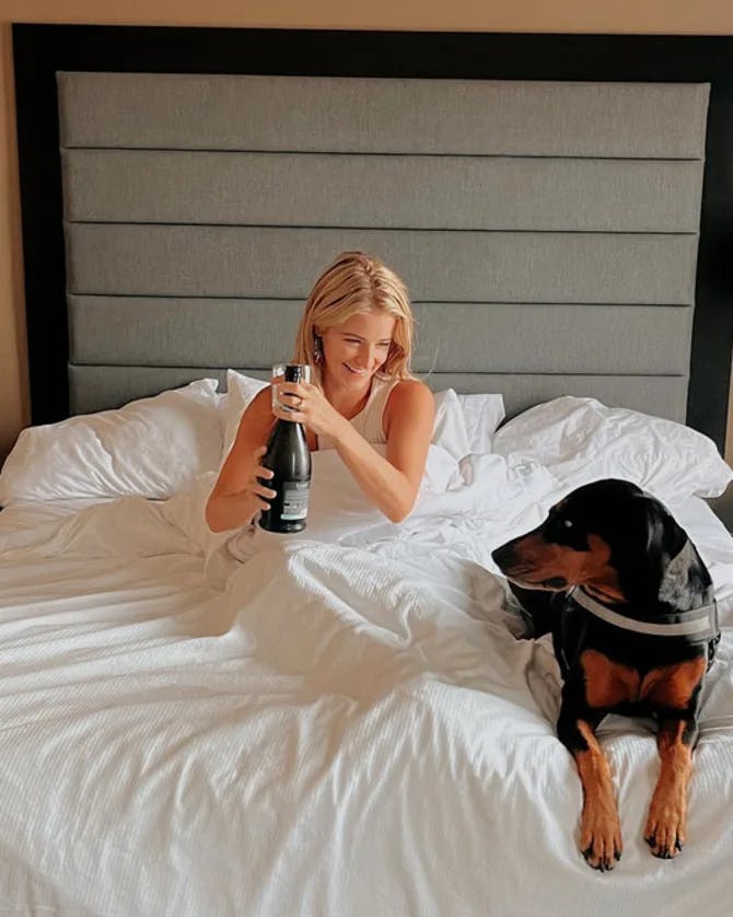 Picture of Sara in bed with dog