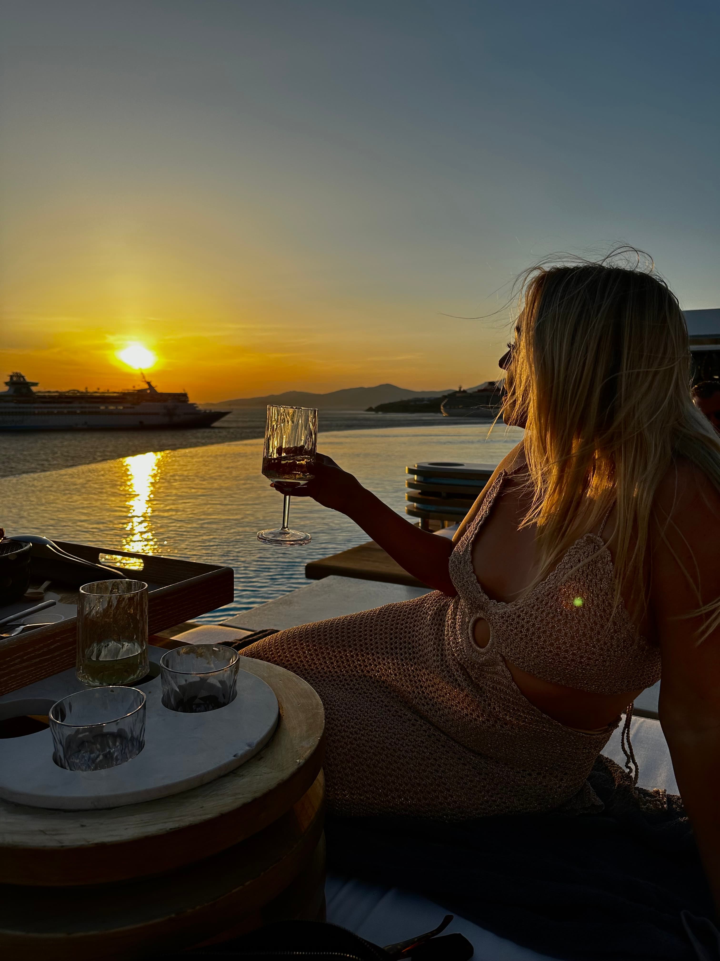 Posing for a photo holding a glass of drink
