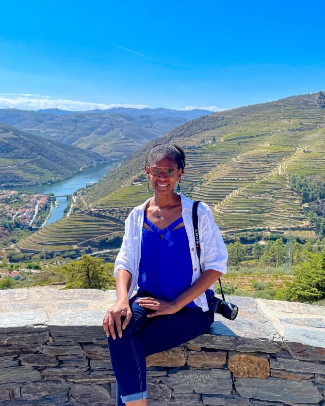 Girl sitting in front of Douro Valley. 