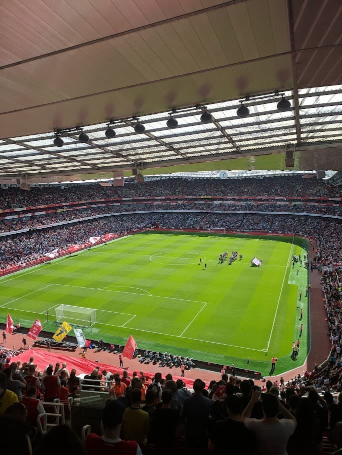 A view of a stadium with a crowd of people and a field
