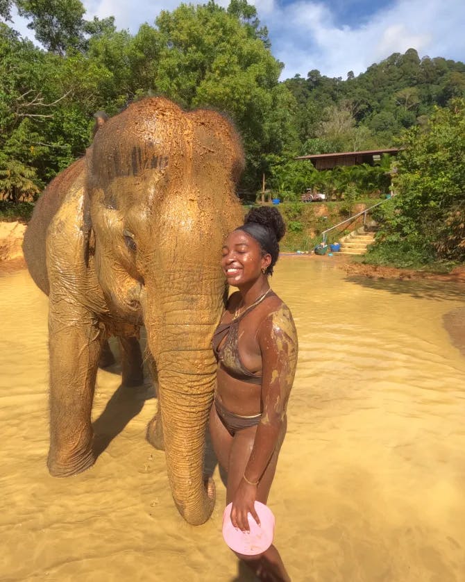 Girl next to elephant. 