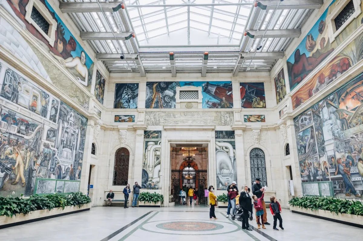 A hall of colorful murals inside the Detroit Institute of Arts