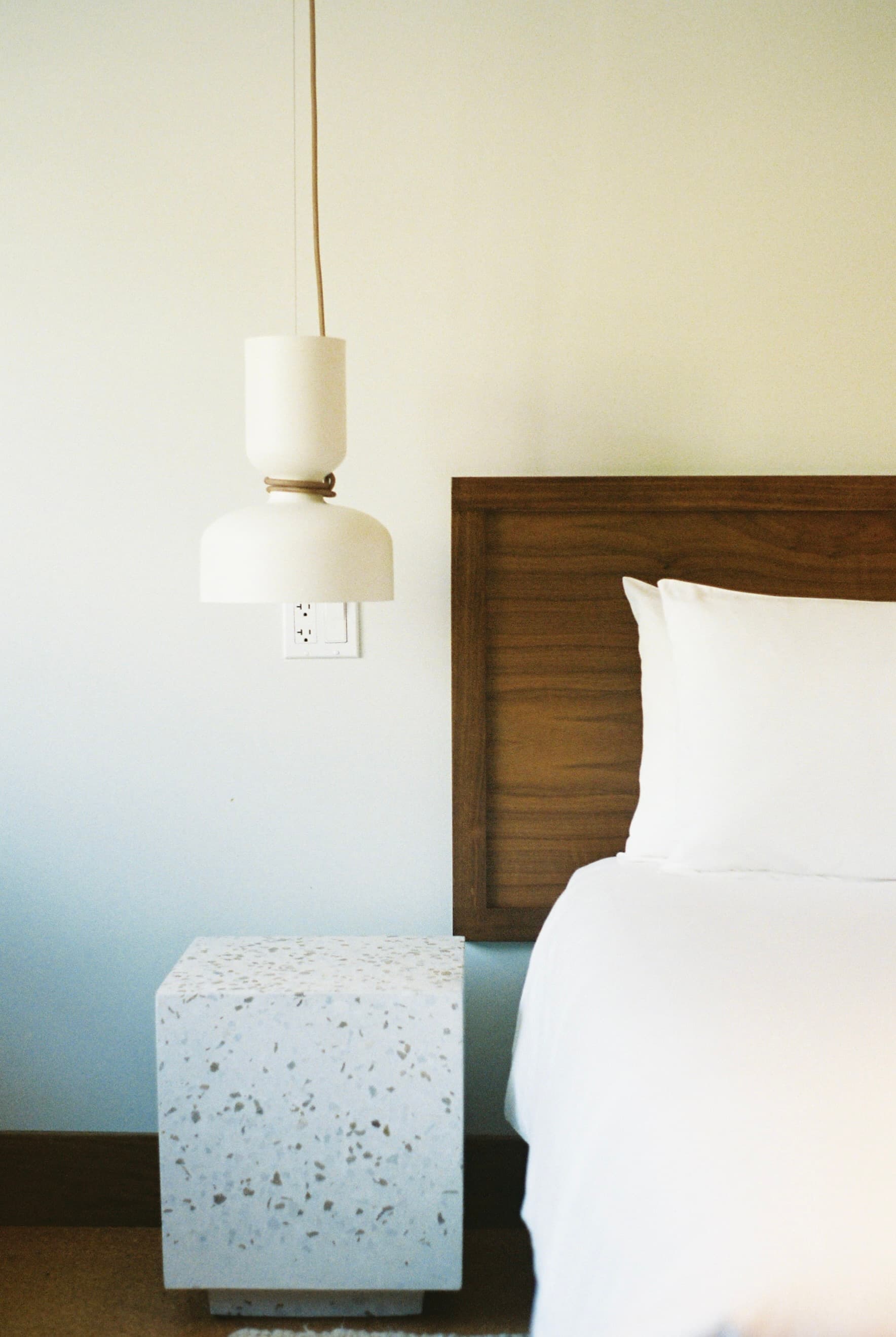 Terrazzo side table and beautiful pendant lamp in a hotel room