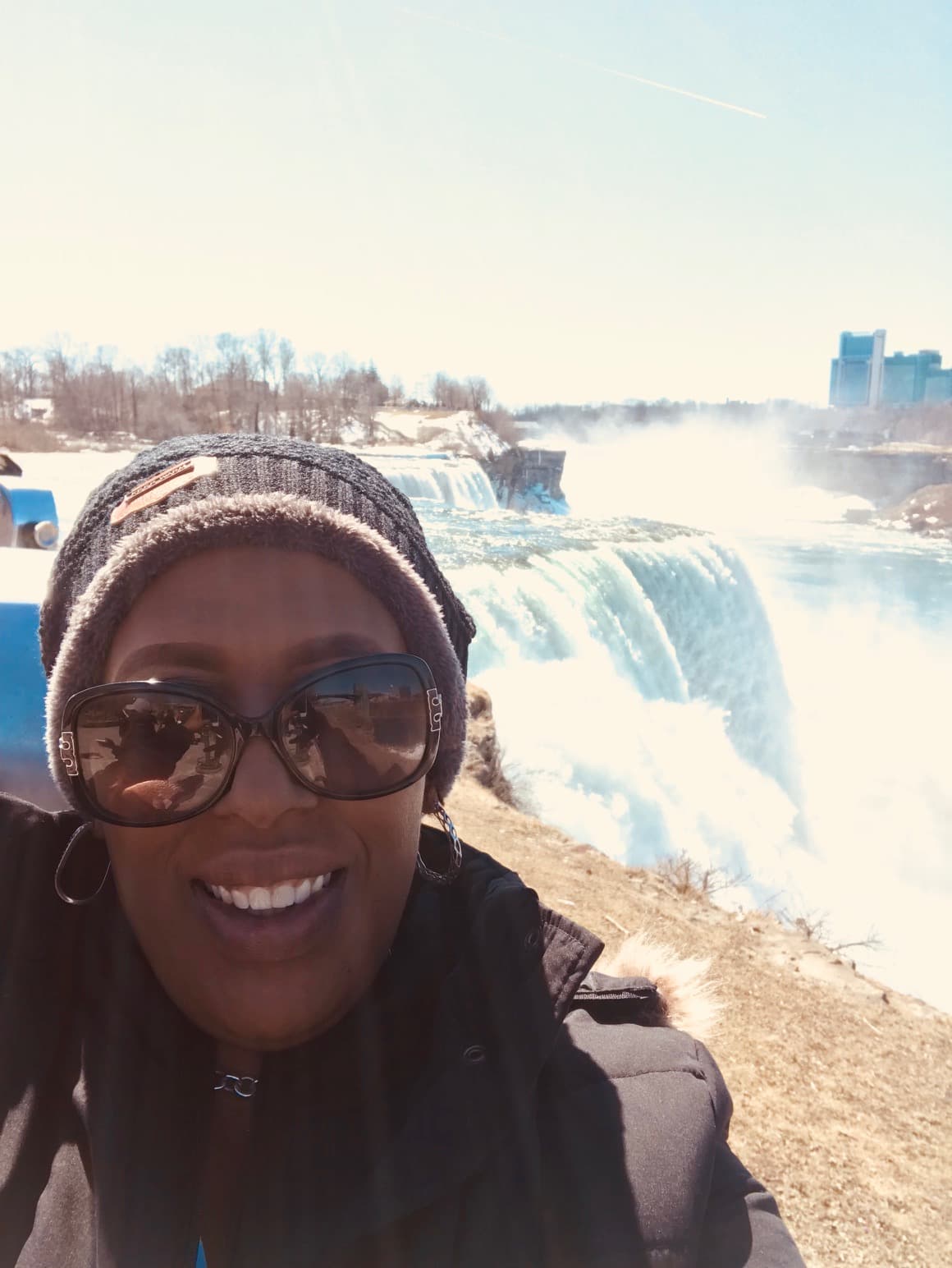 Angela standing on an overlook of a waterfall