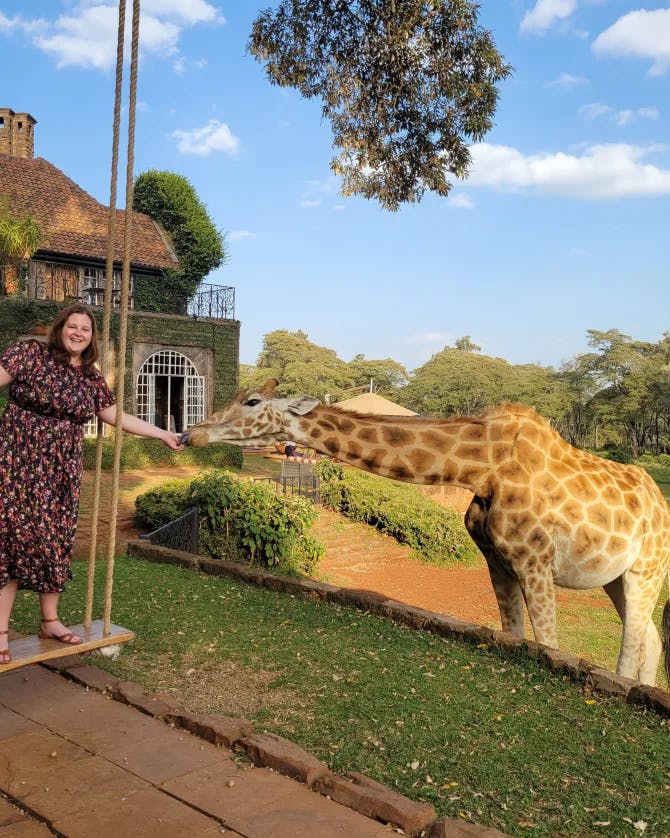 Travel Advisor Nadia Bess feeding a giraffe.