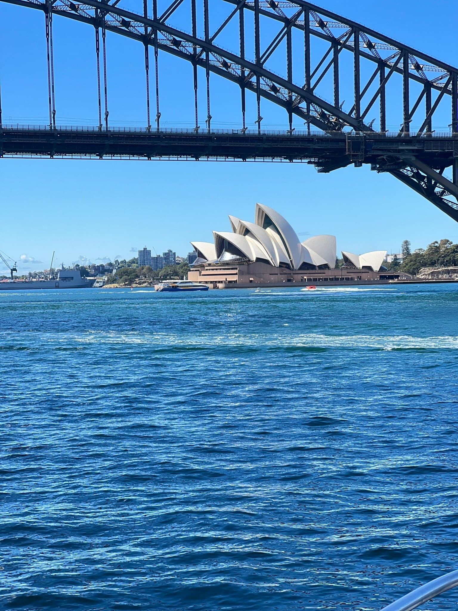 A beautiful view of the ocean with architecture buildings in the distance