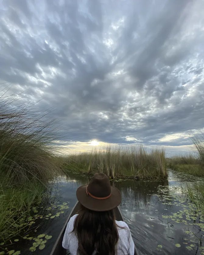 Travel advisor Marissa Morrill sits in a canoe on a calm pond