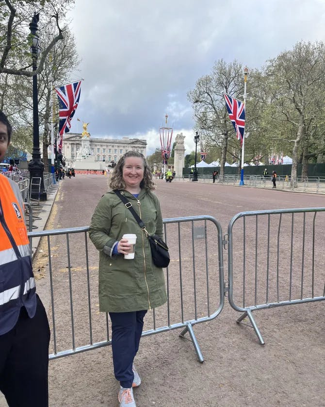 Posing for a picture with Buckingham Palace in the background