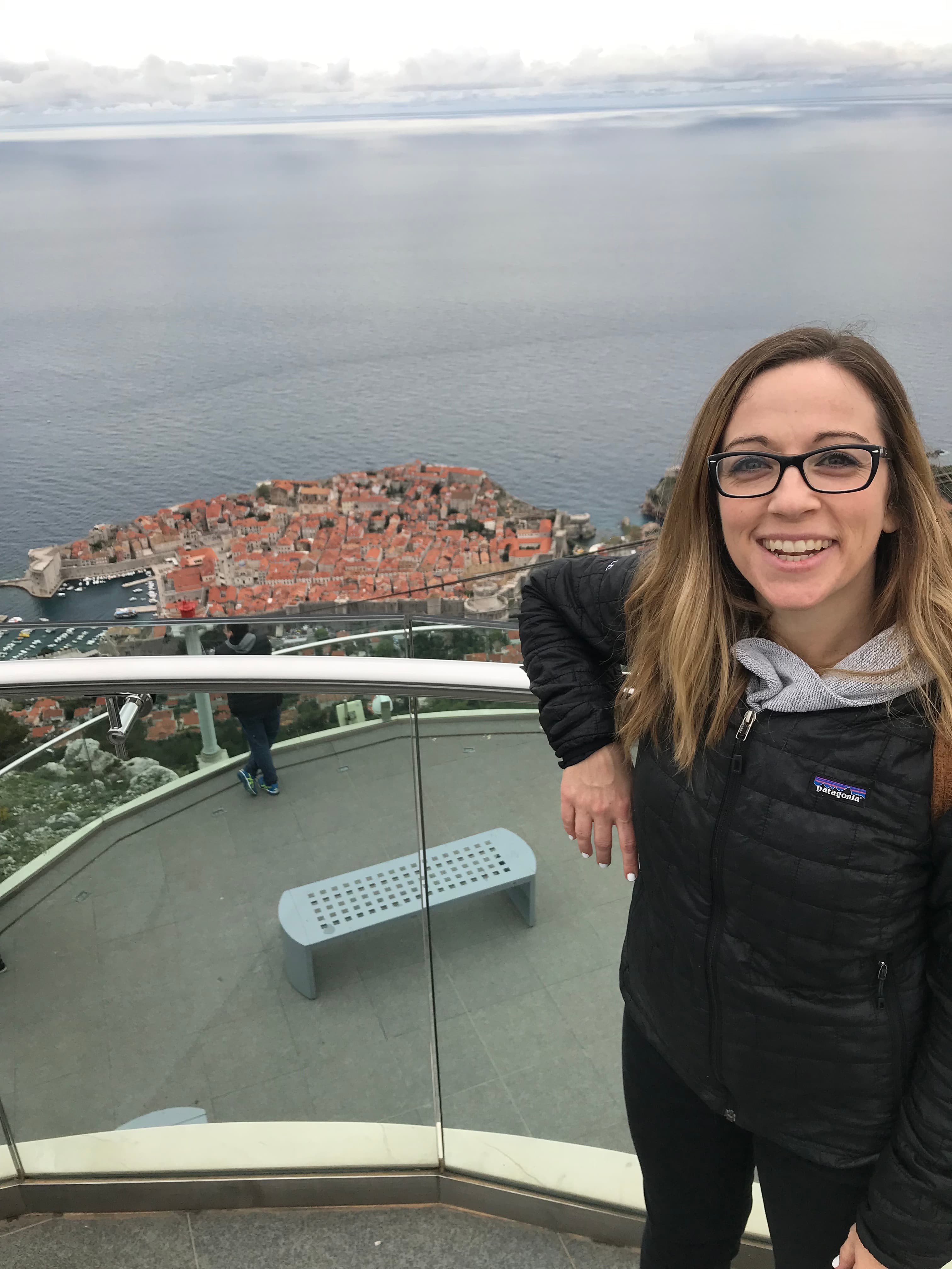Travel advisor posing beside a sea