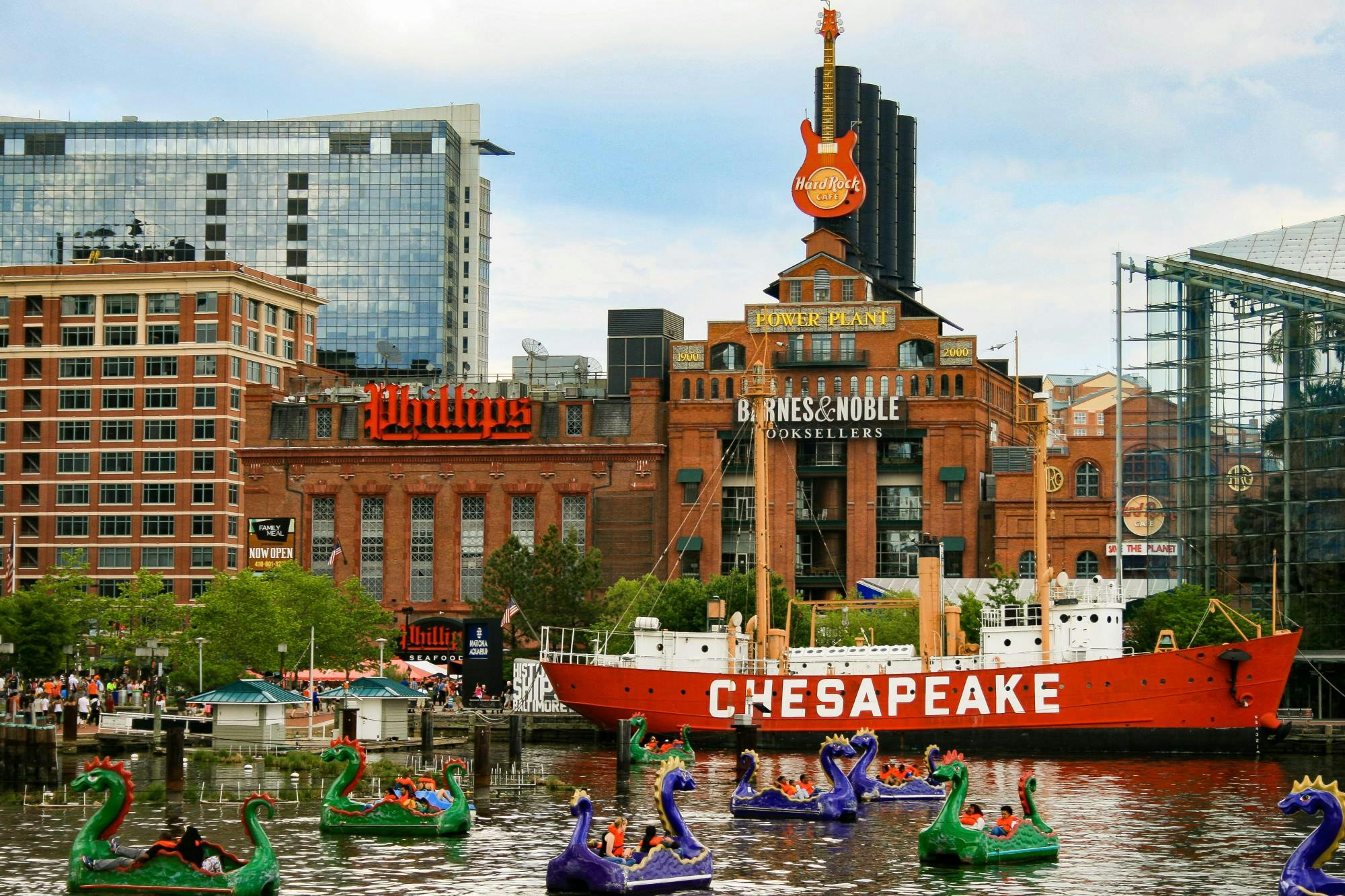Lively Baltimore harbor with dragon boats flanked against old brick buildings