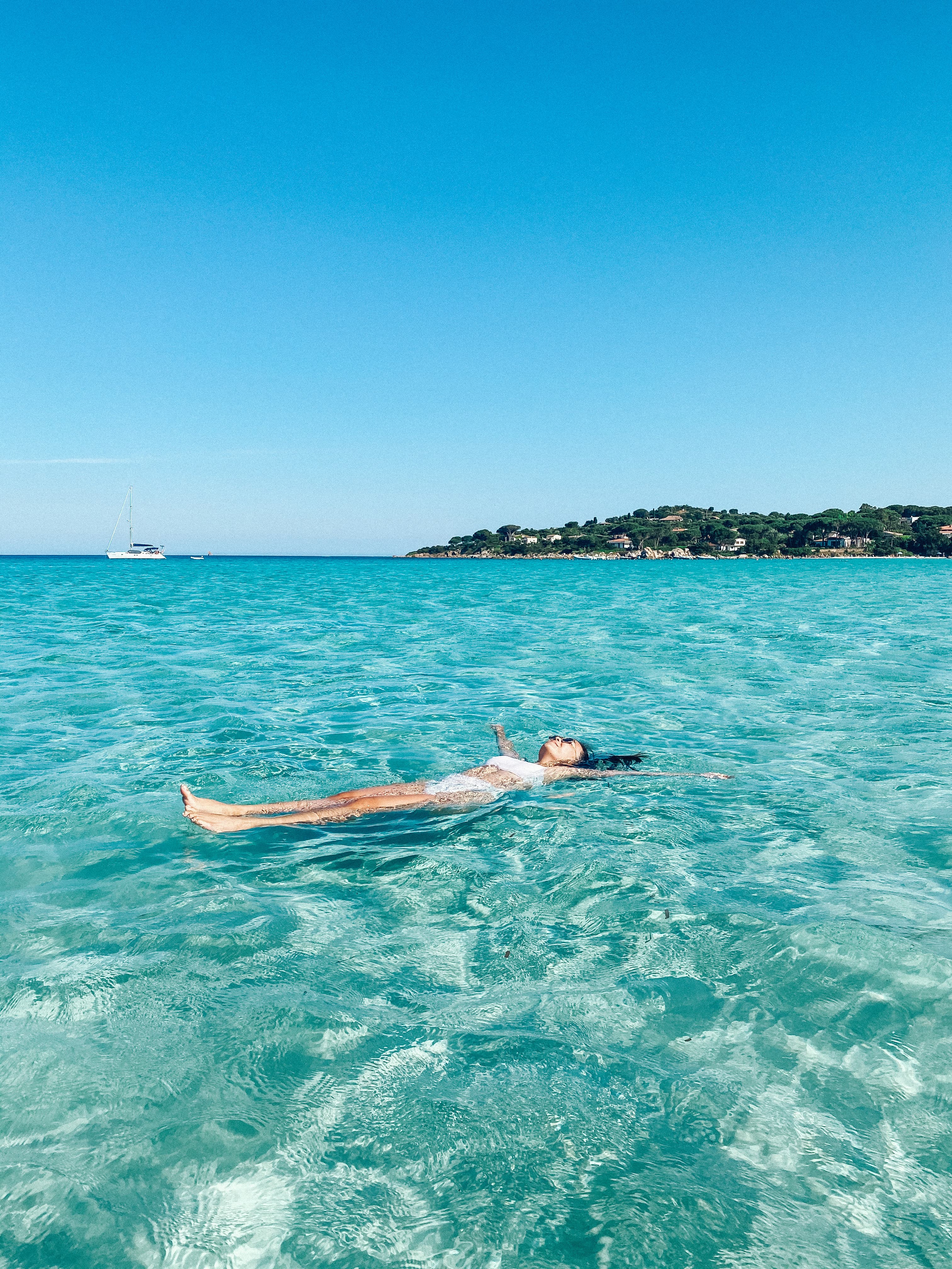 Travel advisor floating in a crystal clear blue sea.