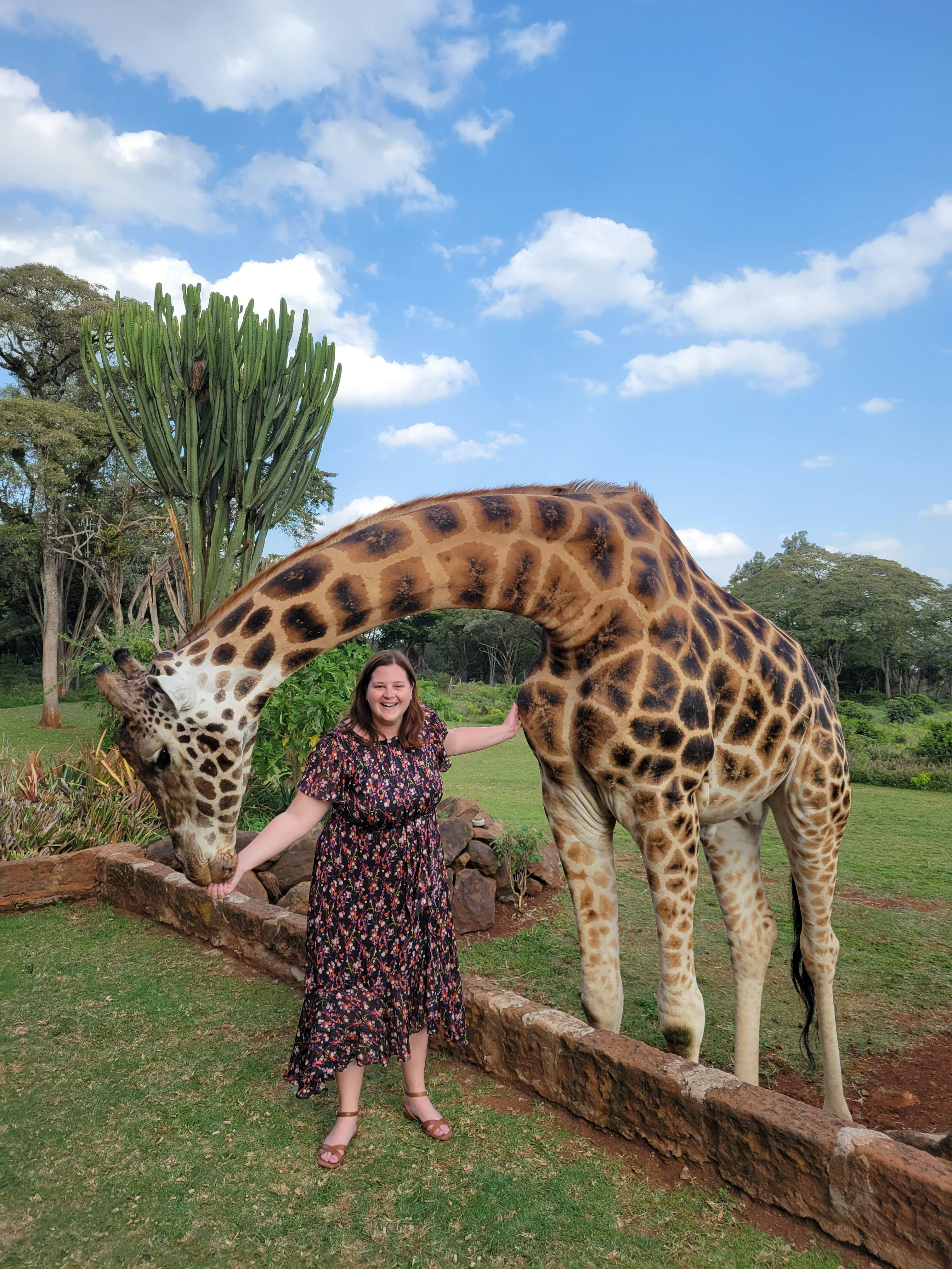 Fora travel agent Nadia Bess standing with giraffe