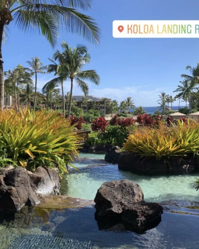 View of Koloa Landing Resort surrounded by rocks, a pool and tropical landscaping
