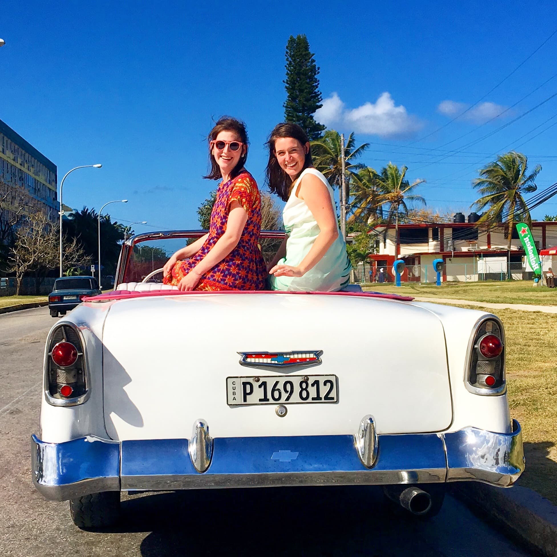 Females sitting on a car's top