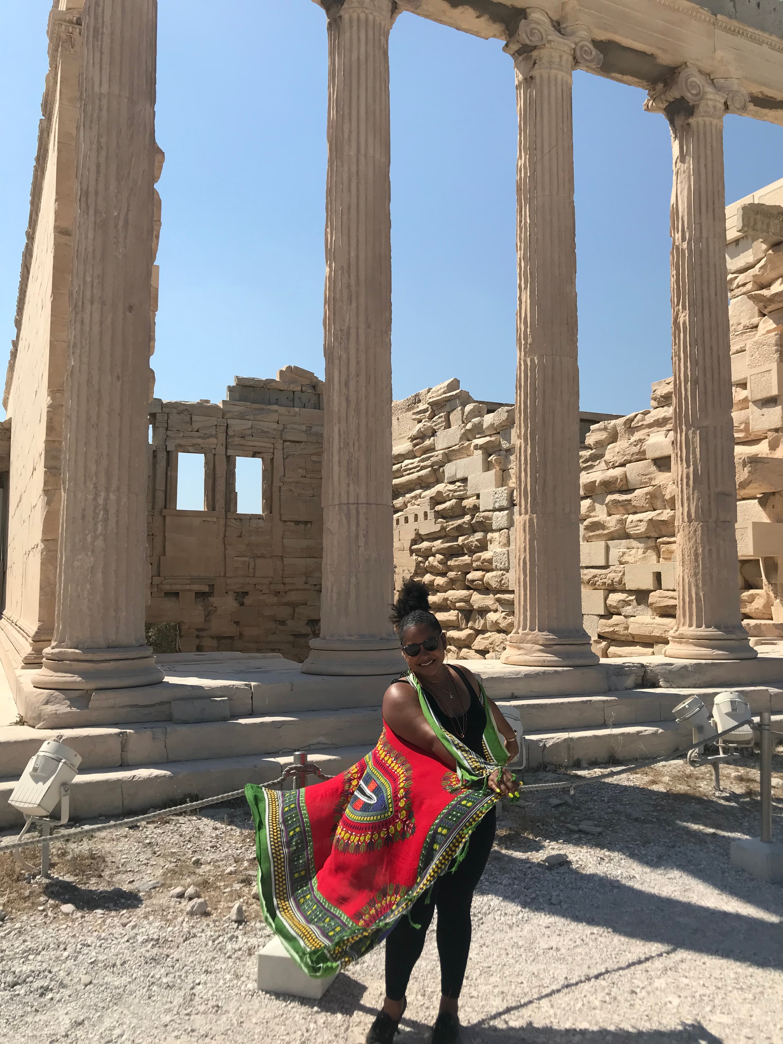 Fun pose in Athens atop the Acropolis in front of the ancient columns of the Parthenon.