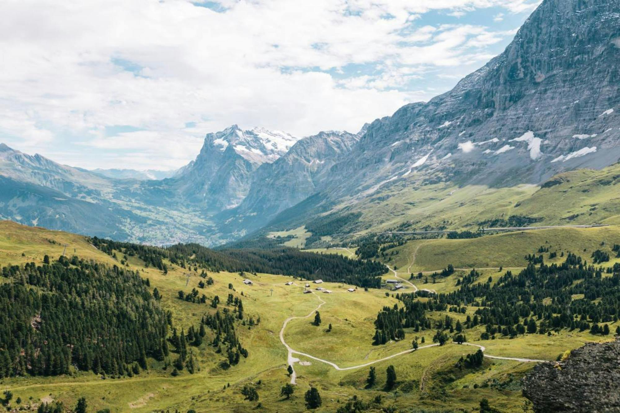 Majestic Swiss Alps towering over a green valley.