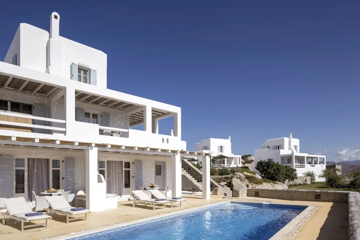 Whitewashed villas with private pools in a row 