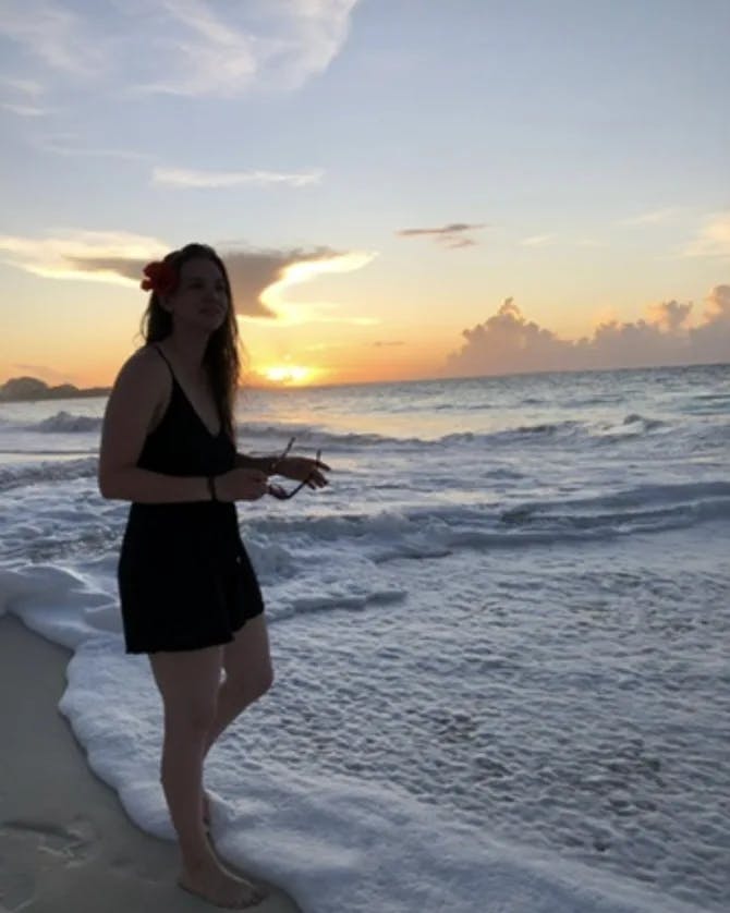 Picture of Nicole in black dress at sunset in beach