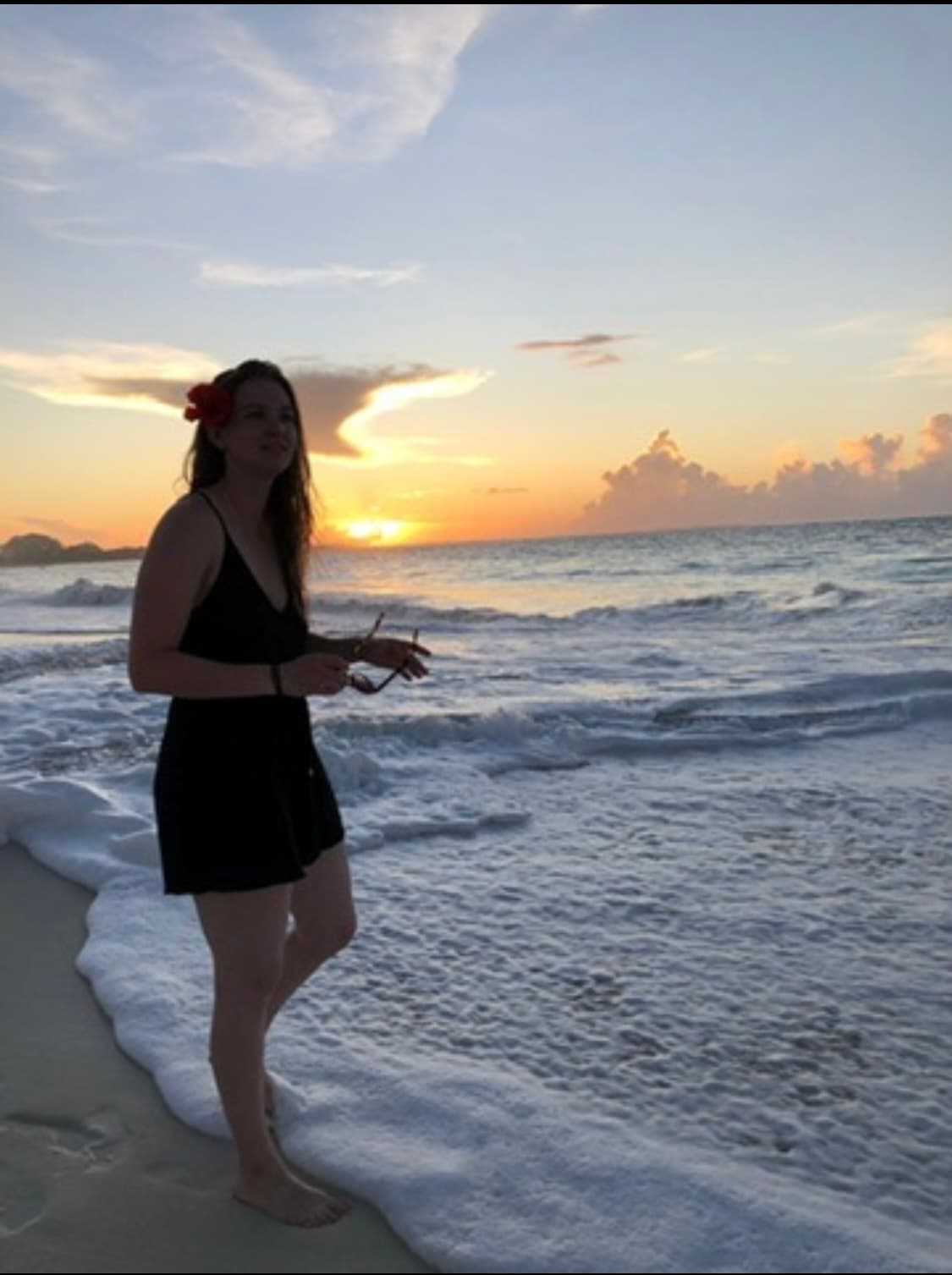 Picture of Nicole in black dress at sunset in beach