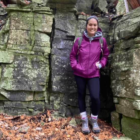 Deanna posing in purple jacket