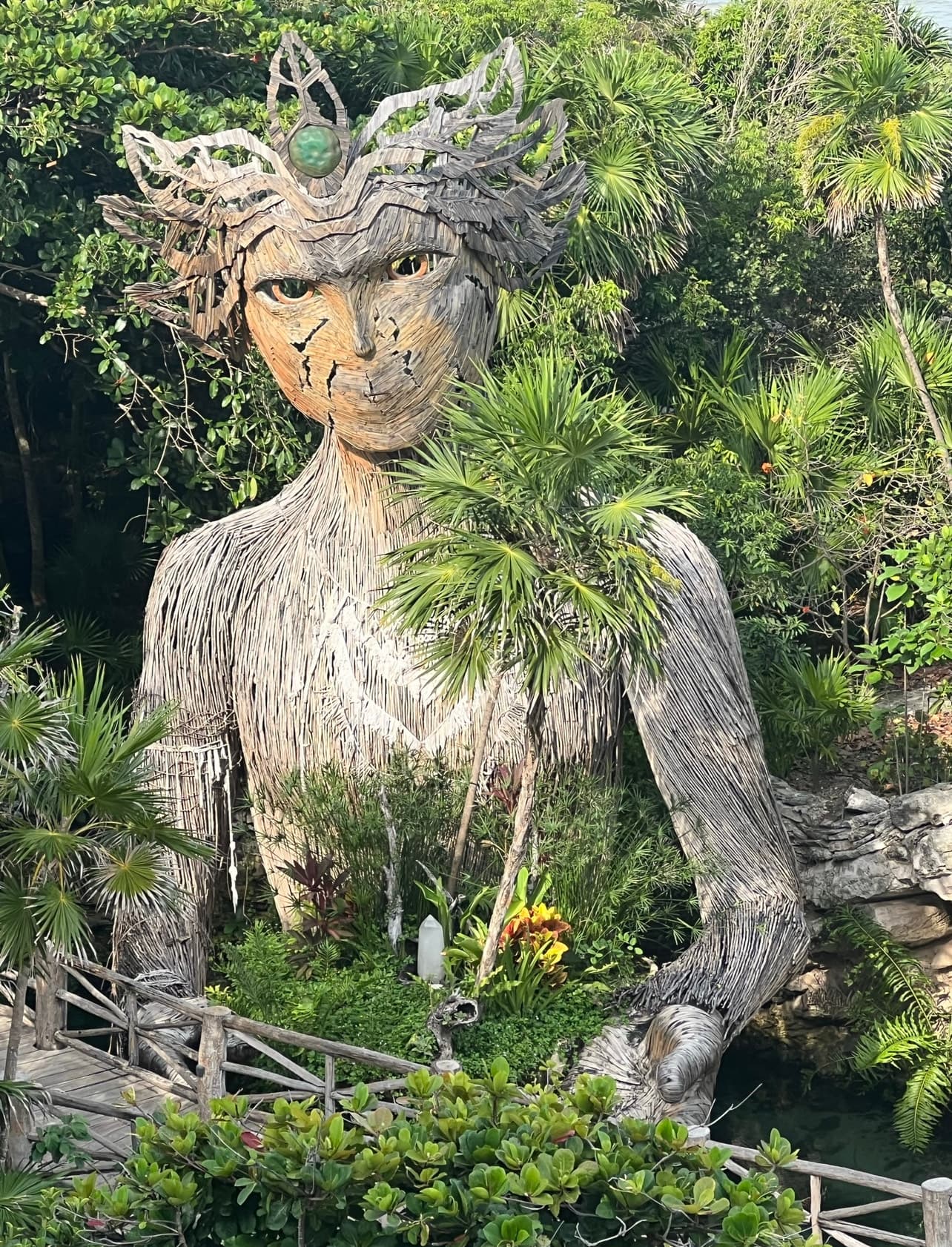 A statue within green trees