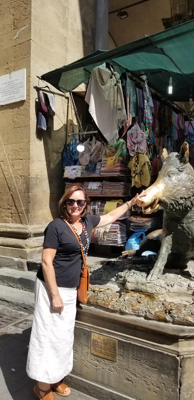 Posing for a photo with a sculpture