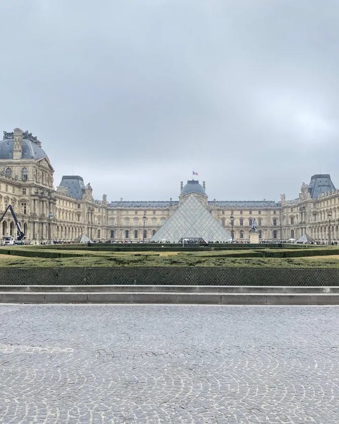 photo of Paris with the Louvre far in the distance with amazing gardens surrounding the area. 