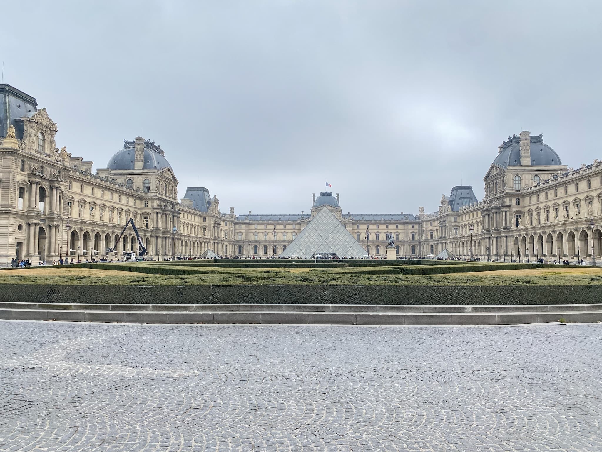 photo of Paris with the Louvre far in the distance with amazing gardens surrounding the area.