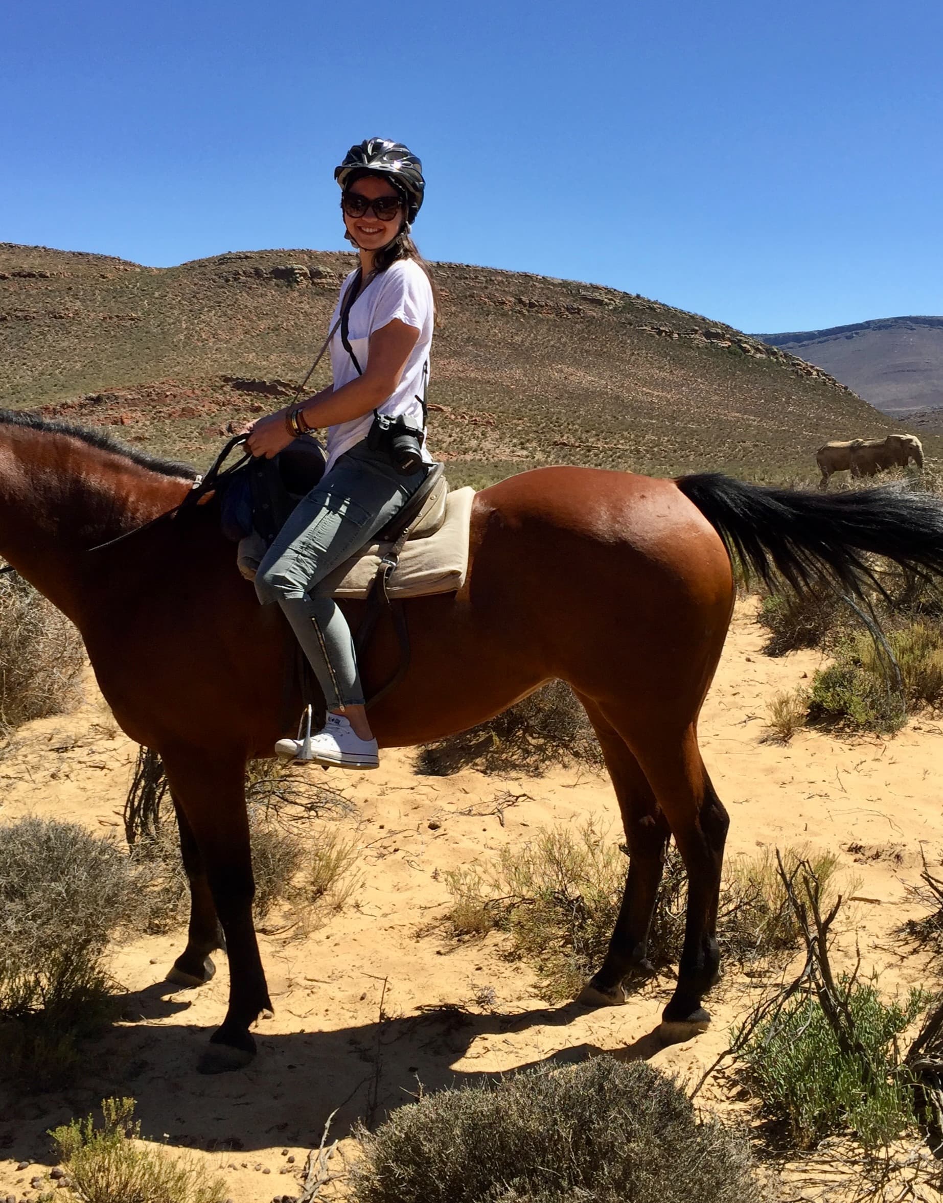Madison riding a horse in a western setting