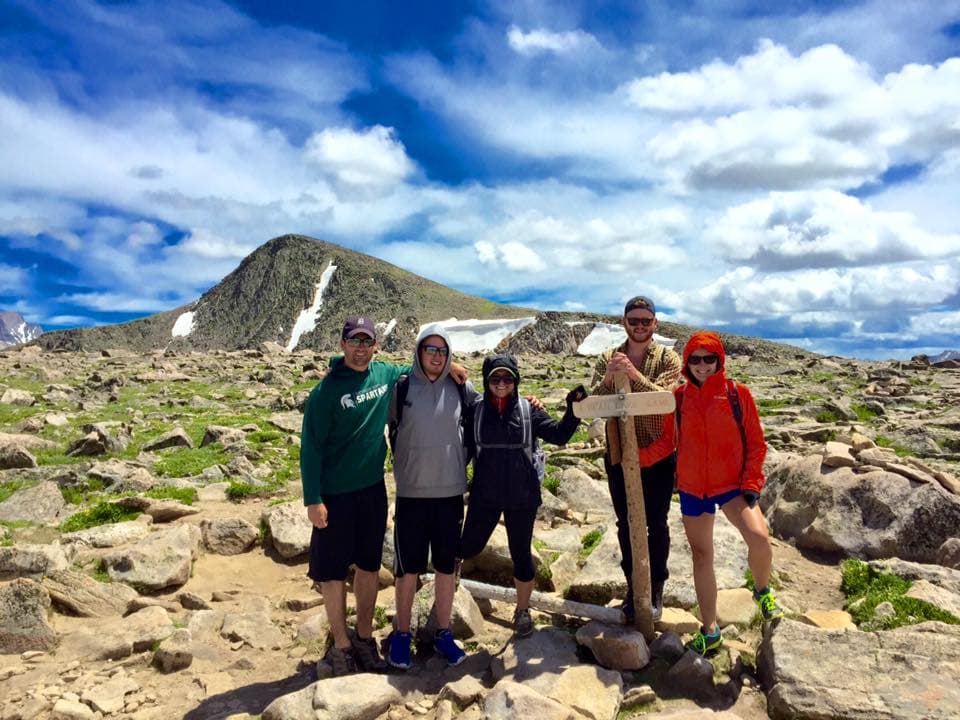 Travel advisor posing in a valley