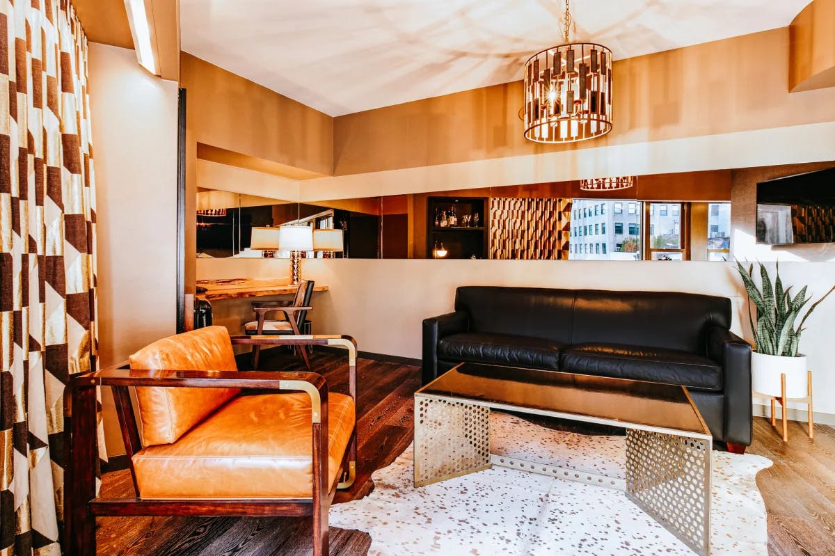 a chic living room with a caramel-colored leather couch