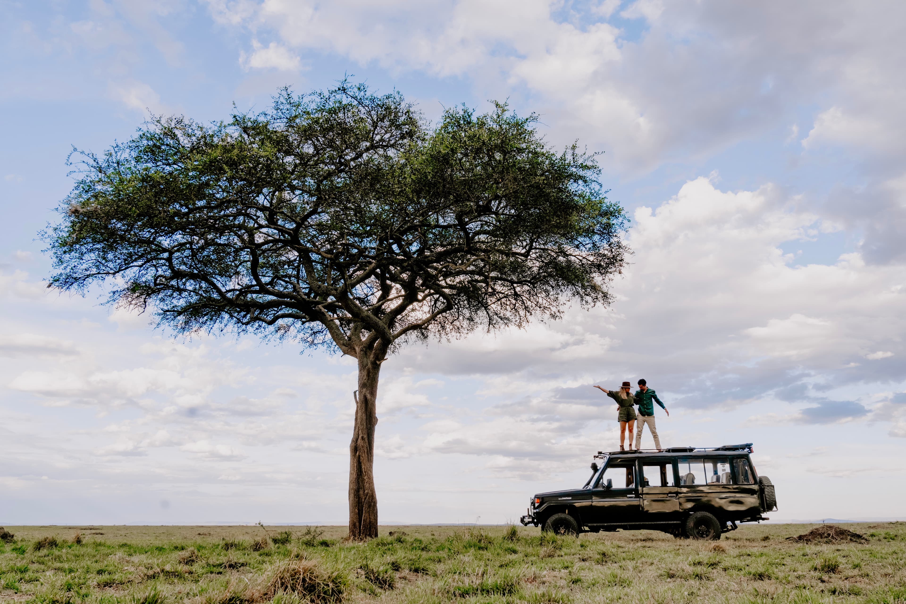 Posing for a picture on top of a jeep