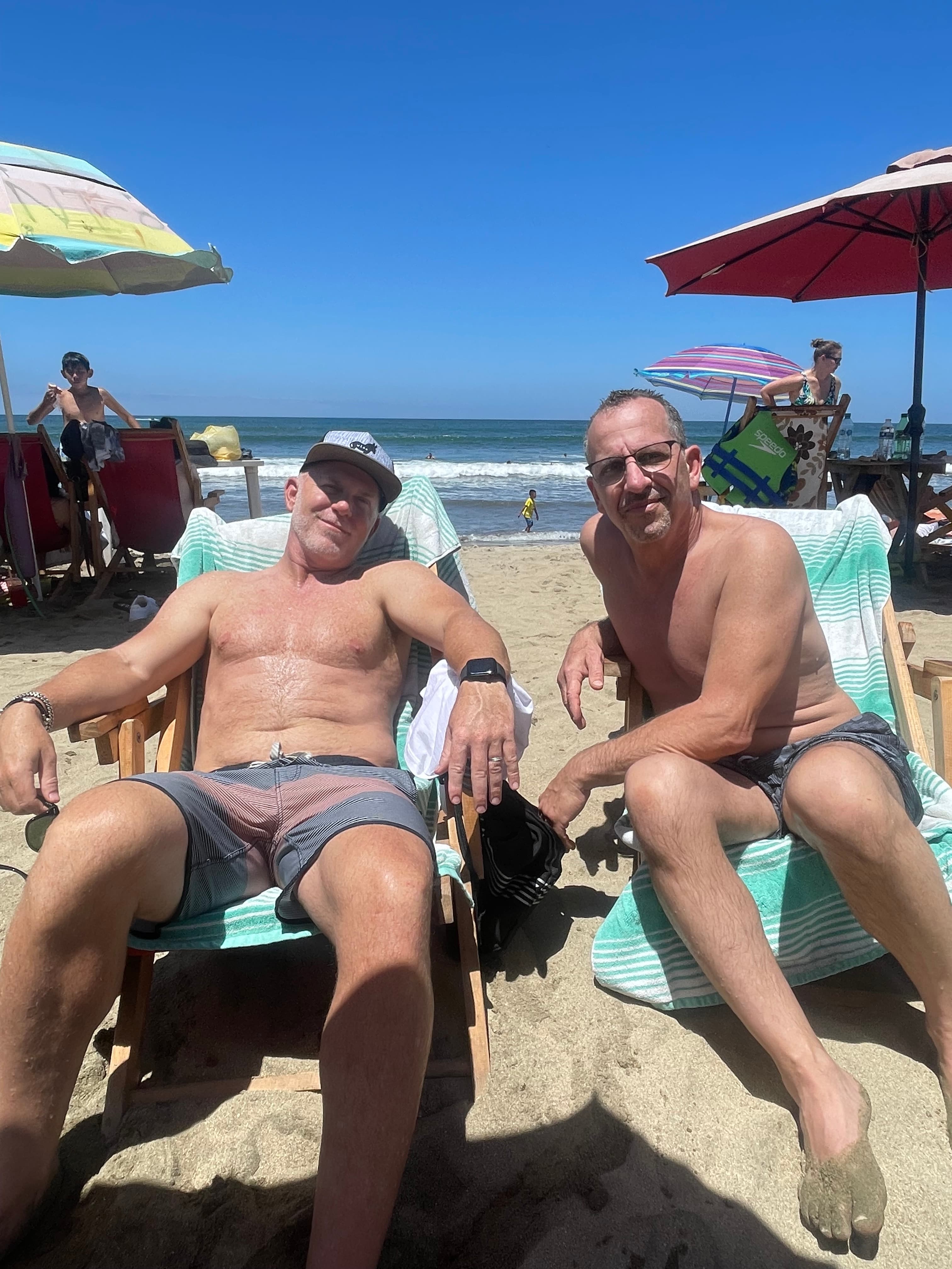 Picture of man sitting on loungers on beach