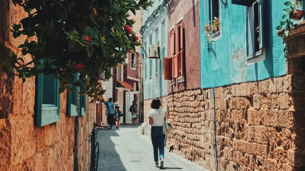 Colorful, sunny Lebanese backstreet with a woman walking