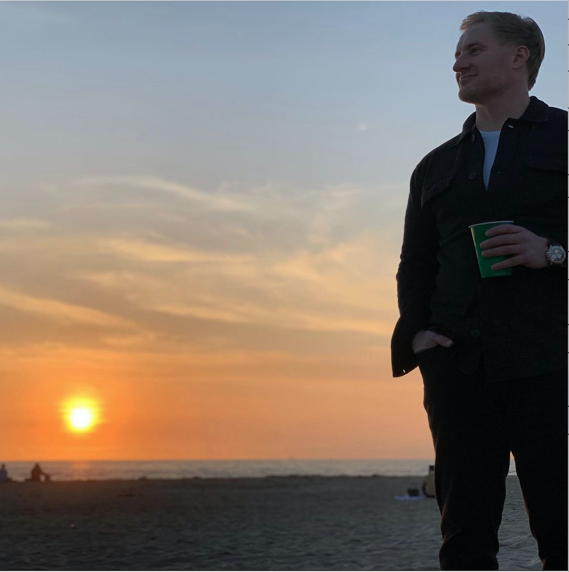 Travel Advisor Drew Haas admiring the sunset at a beach.