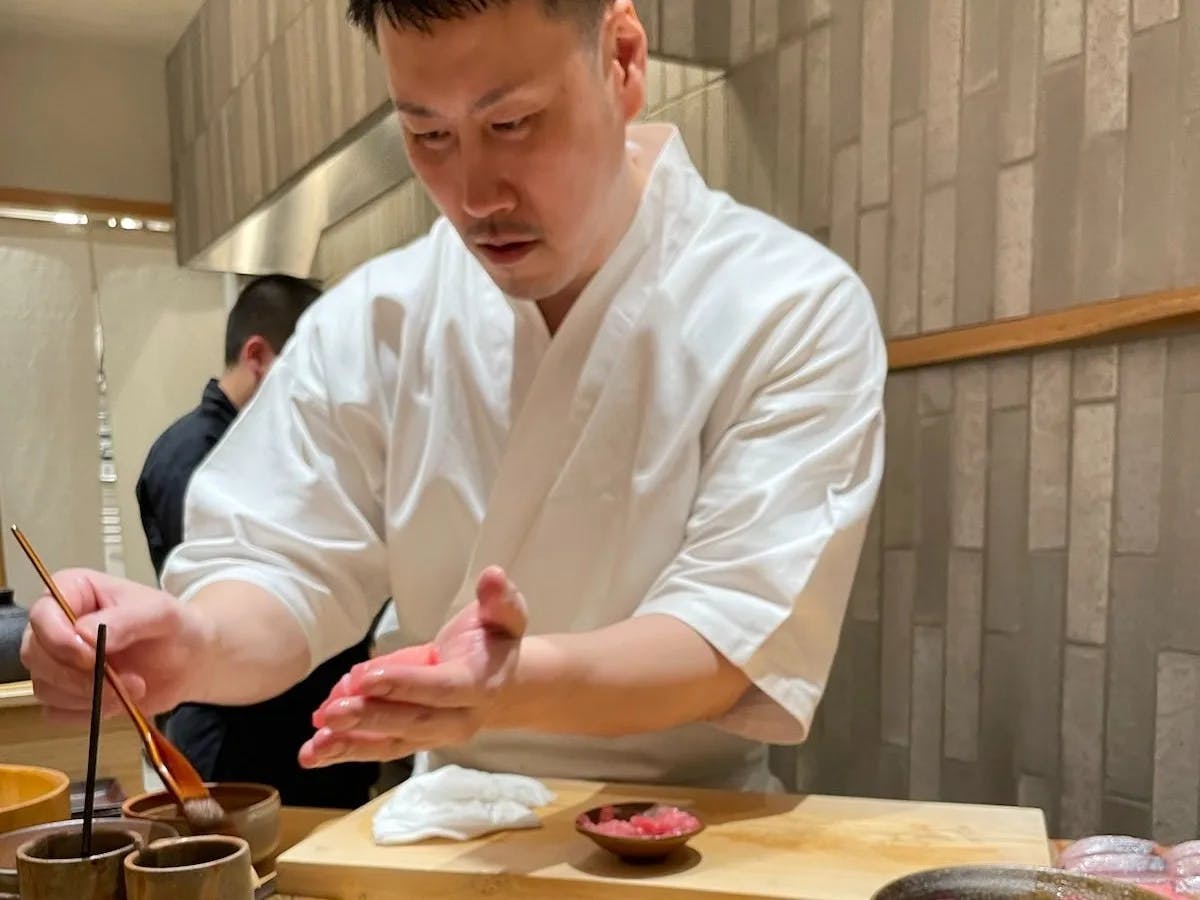 A chef making sushi wasabi in a restaurant. 