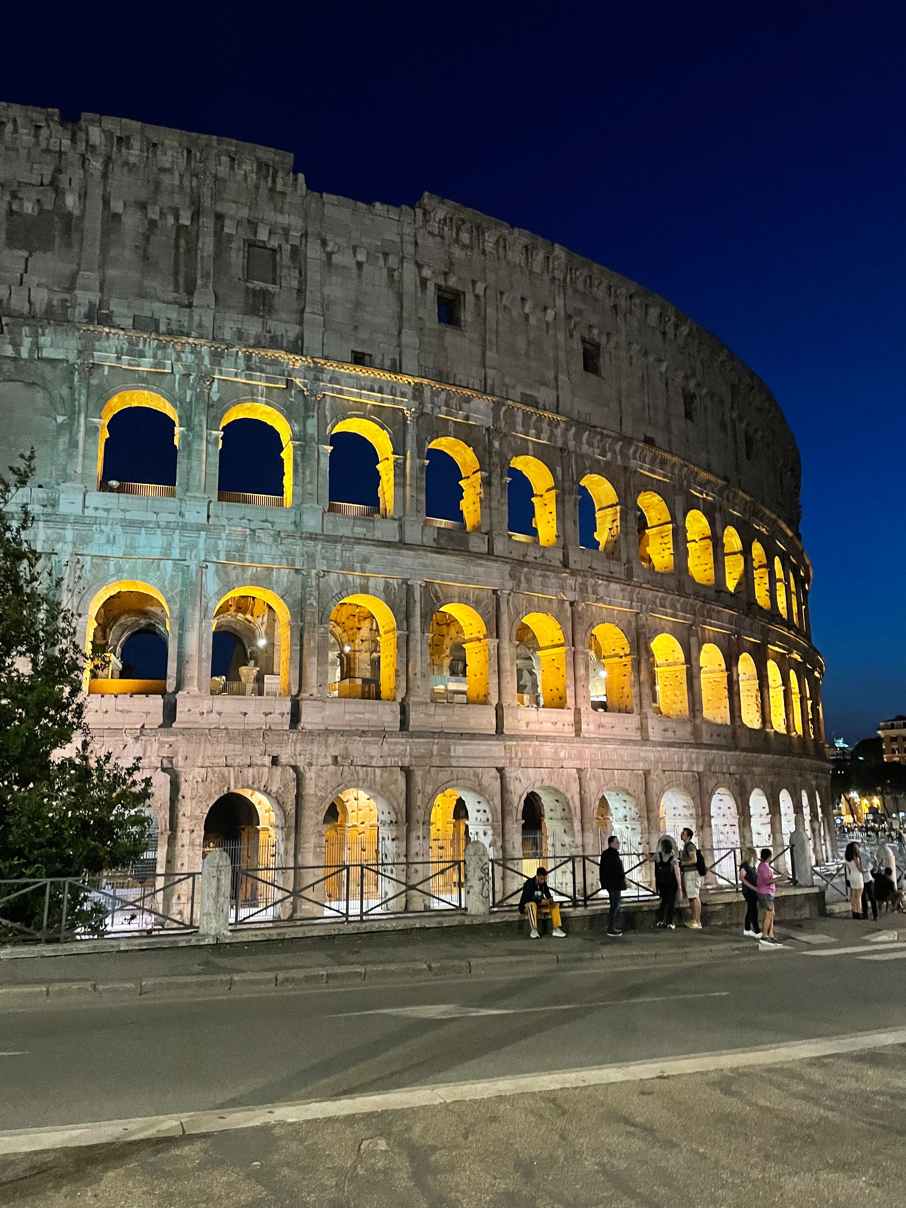 colosseum lit up at night time