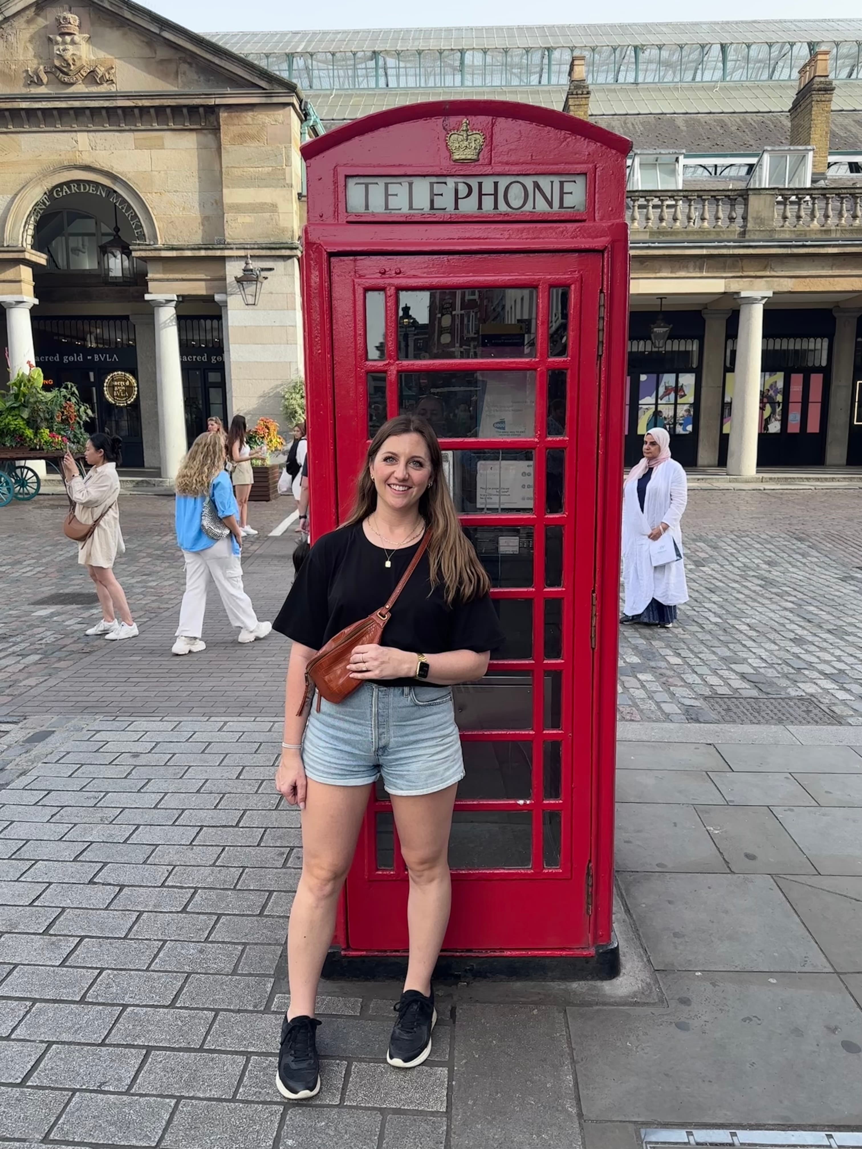 Girl infront of Red phone booth