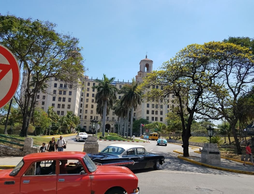 View of a red car and an apartment building