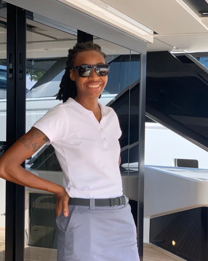Jazmin Paige posing on the deck of a yacht. 