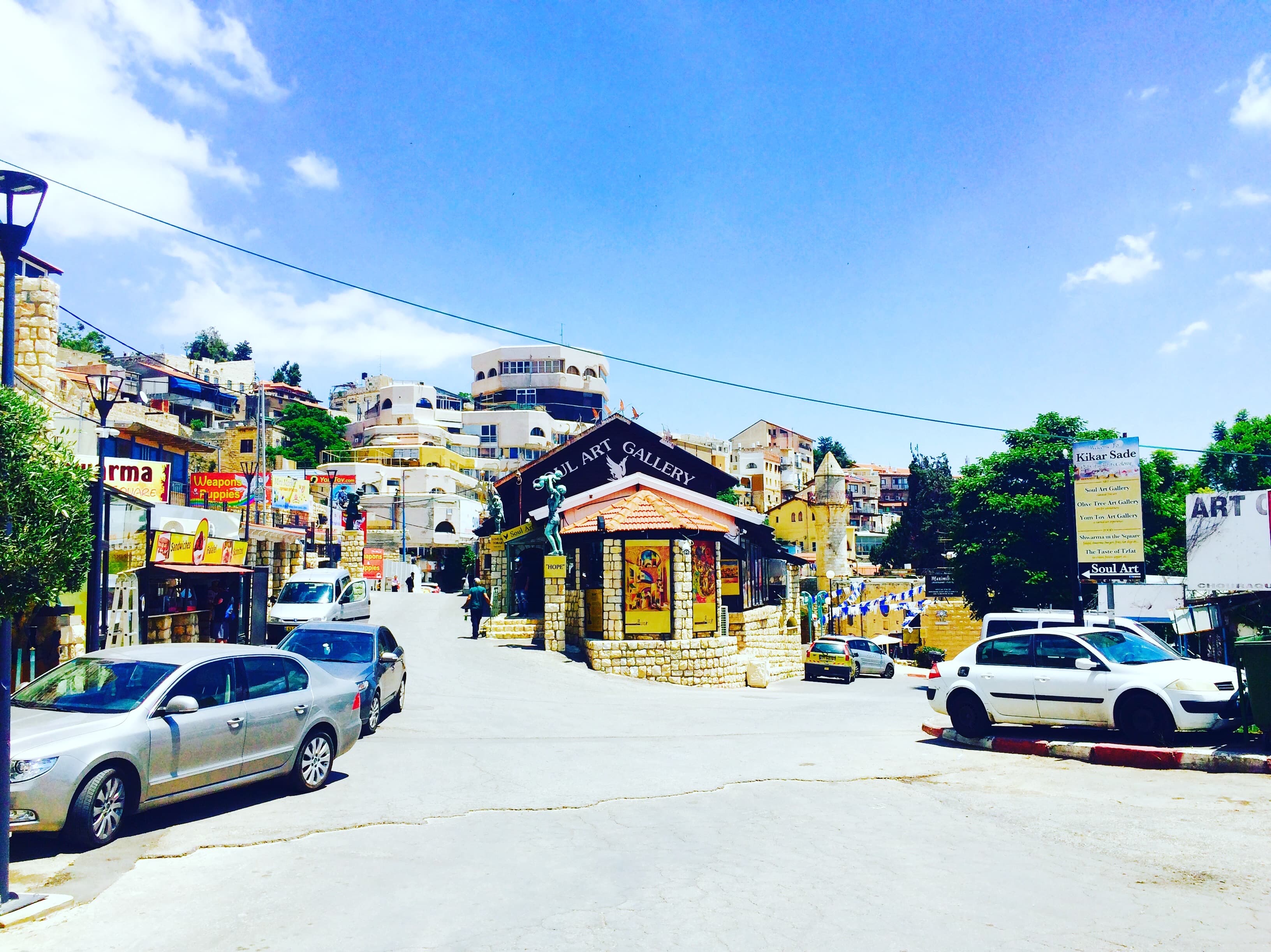 A local market picture with shops and cars