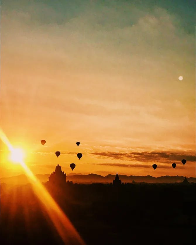 Balloons over a sunrise in Bagan.