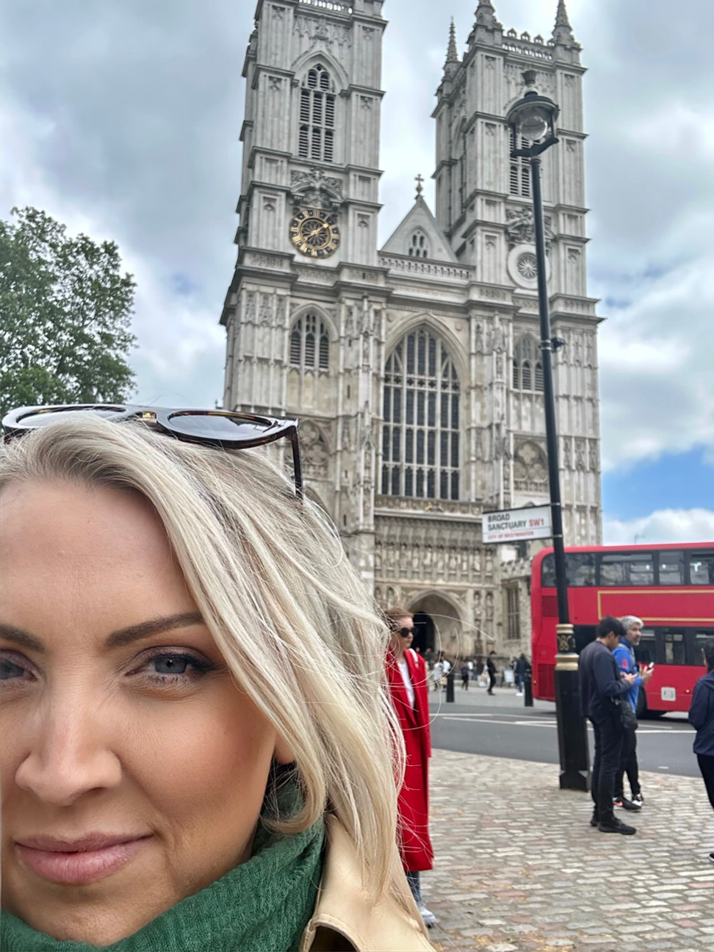 Travel advisor posing in front of a building