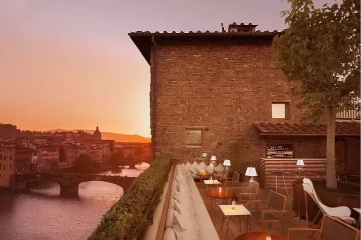 From the chic rooftop lounge of Continentale in Florence, the grand canal is visible at sunset