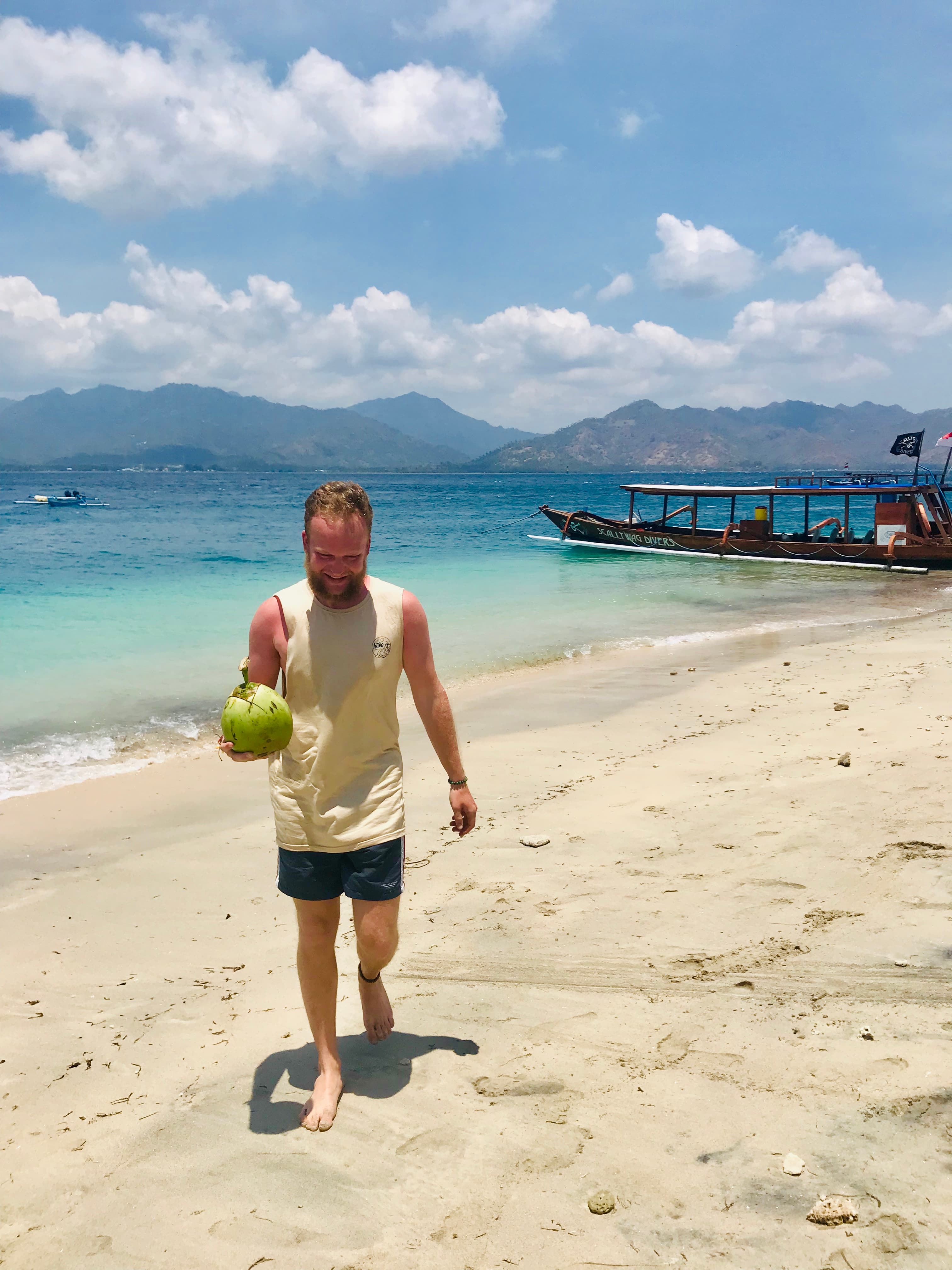 Having coconut water on the beach