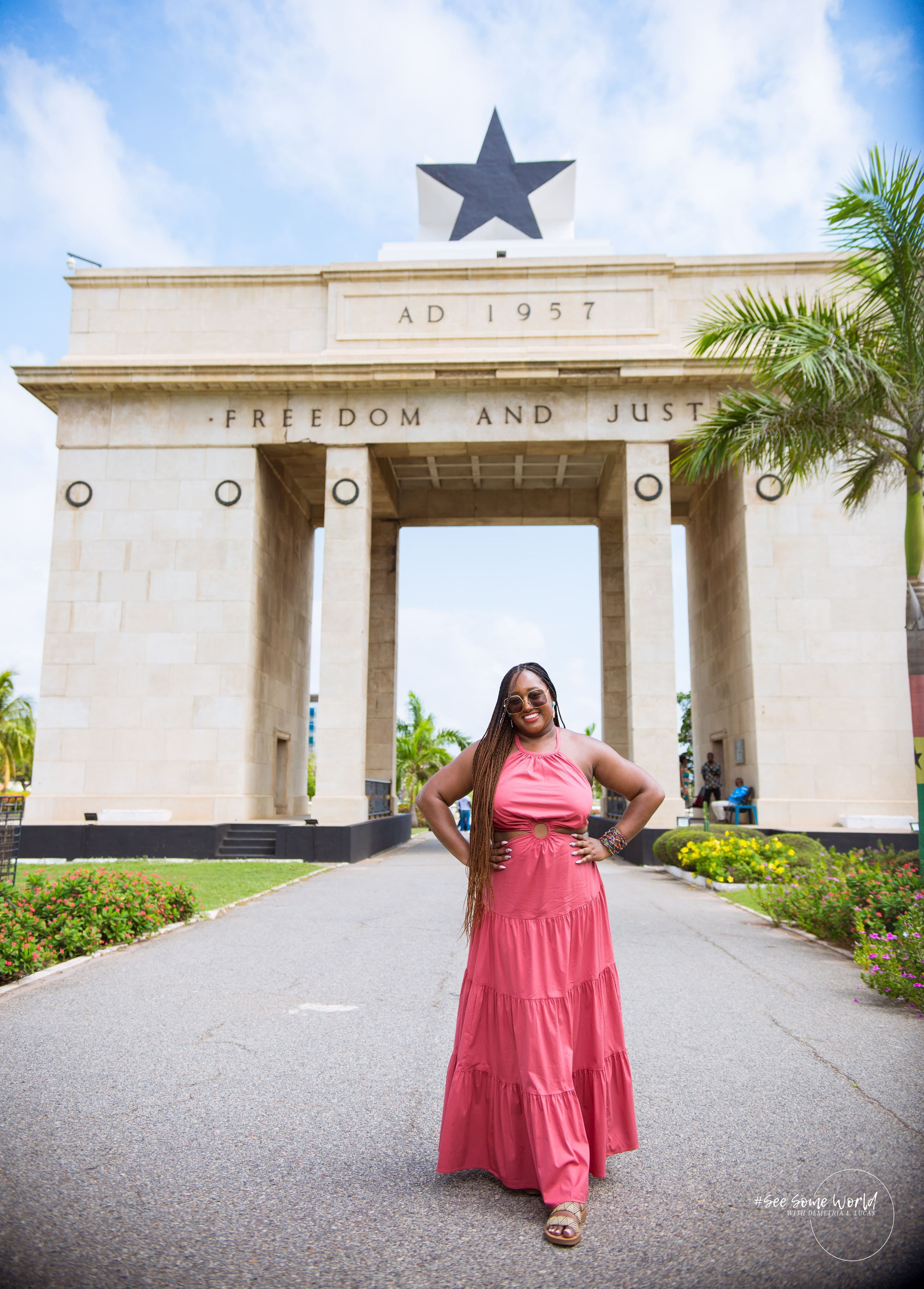 tasia in front of a building in pink dress