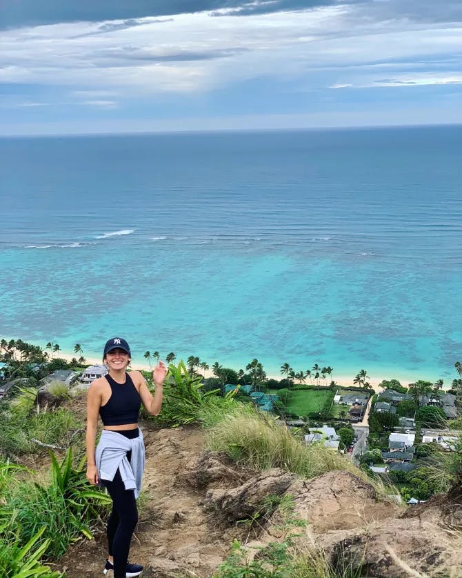 Picture of Shelby hiking at Lanikai Pillbox with an aerial view of the light blue ocean